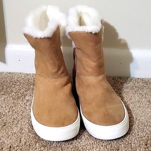 Tan and white girls fury boots.